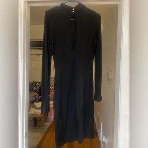Black form fitting dress with peek-a-boo hole and bell sleeves. Gently worn.
